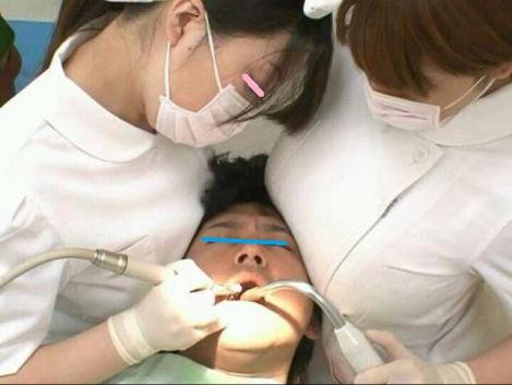 現在も歯周病の治療を女性スタッフの胸に囲まれ圧迫され診察中をデジカメおもしろ写真画像です