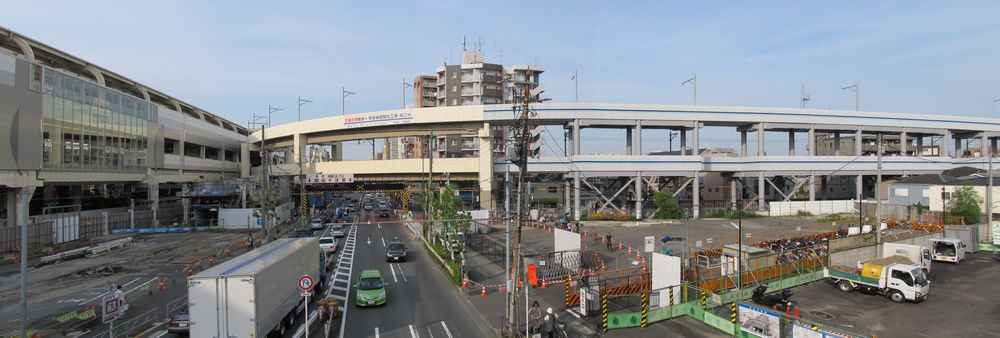 第一京浜をまたぐ新しい歩道橋から第一京浜を見下ろす。右の広い空き地には今後駅前ロータリーが建設される。